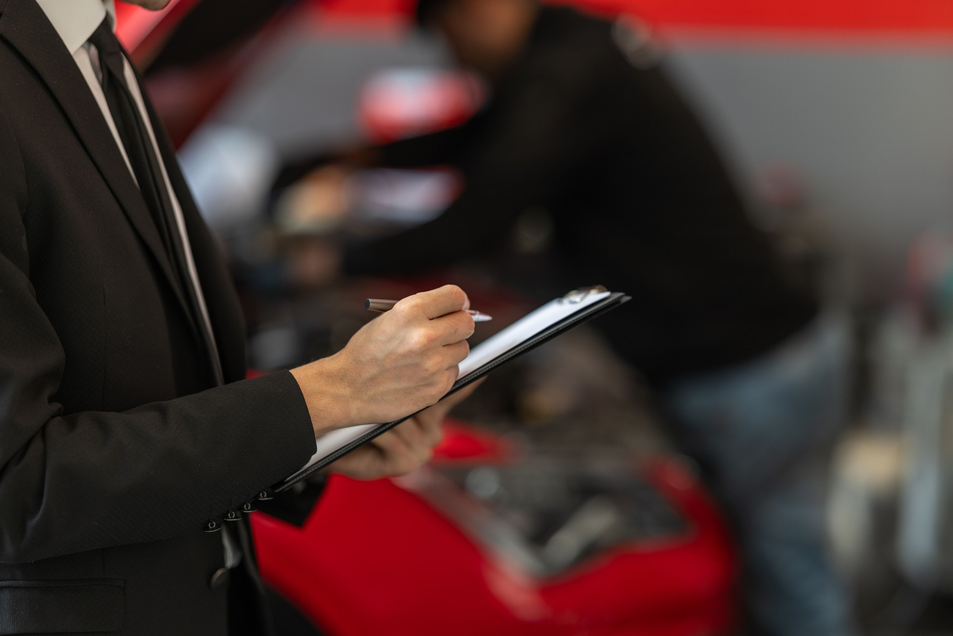 Professional Mechanic Inspecting Vehicle in Auto Repair Shop
